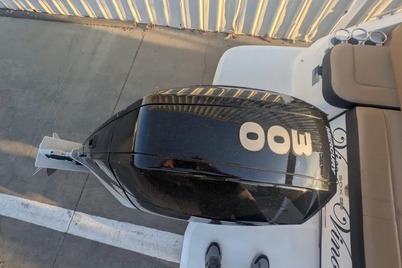 Slide: The Image of 2022 Sea Ray SDX 250 Outboard engine, top view, parked on concrete. - 8