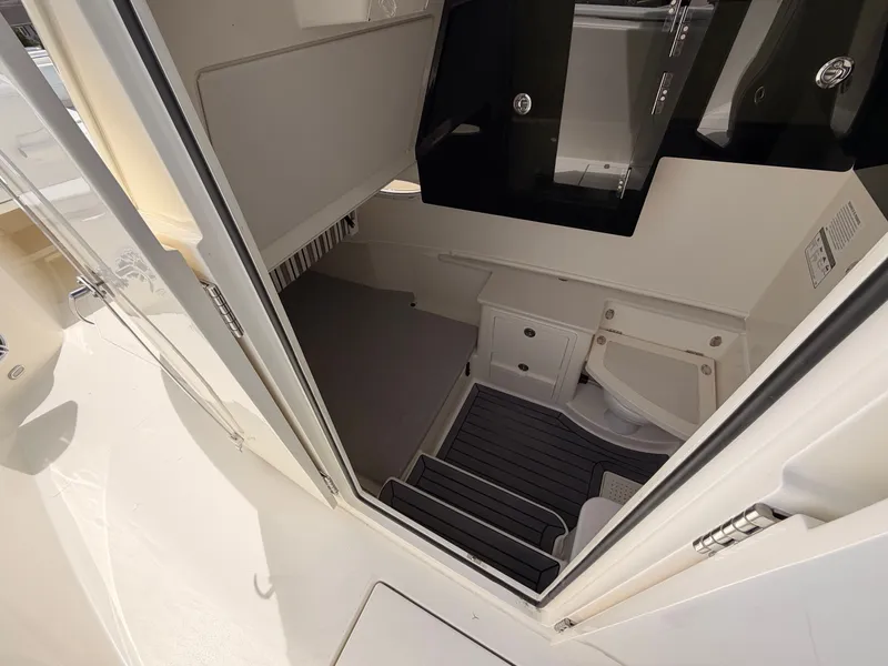 Slide: The Image of Interior of 2025 Cobia 350 Center Console with toilet and storage. - 11