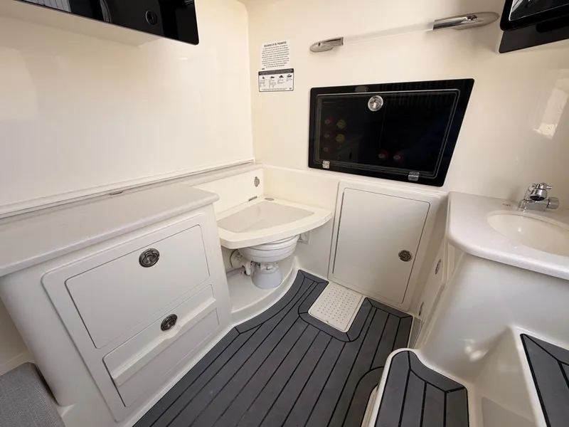 Slide: The Image of Interior of 2025 Cobia 350 Center Console with toilet and sink. - 14