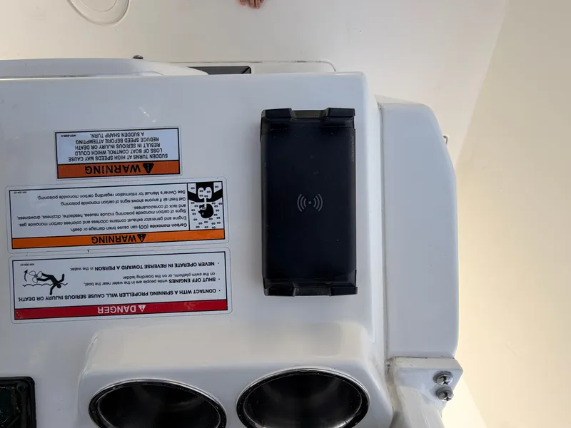 Slide: The Image of Cobia 350 Center Console 2025 with warning labels and charging pad. - 16