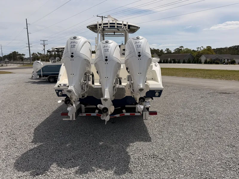 Slide: The Image of 2025 Cobia 350 Center Console with triple outboard engines. - 4