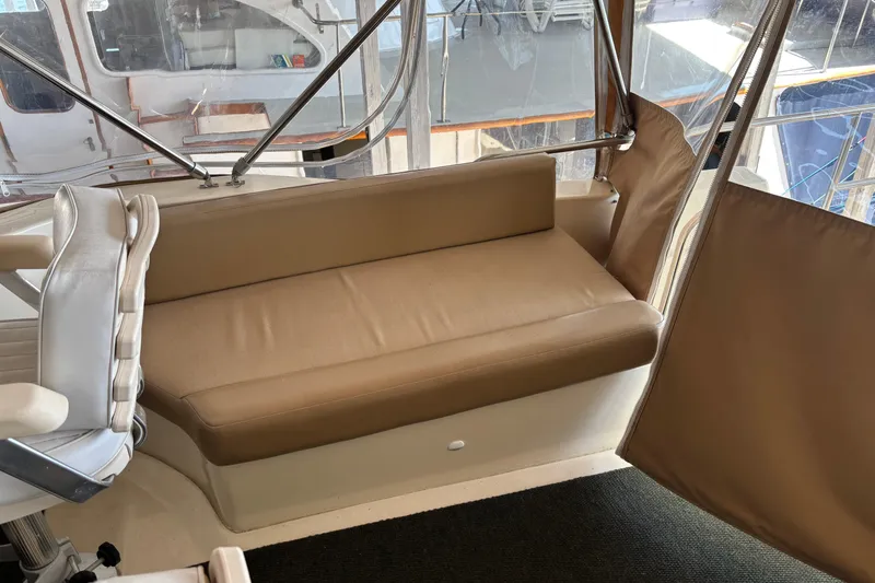 Slide: The Image of 2007 Mainship 34 Trawler interior with beige seating and helm chair. - 10