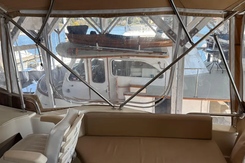 Slide: The Image of Interior view of a 2007 Mainship 34 Trawler with marina backdrop. - 14