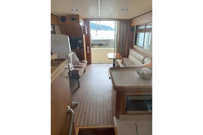 Slide: The Image of Interior of 2007 Mainship 34 Trawler with wood flooring and seating area. - 16