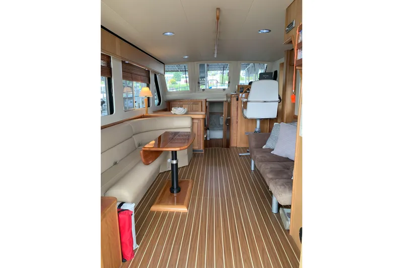 Slide: The Image of Interior of 2007 Mainship 34 Trawler with wood flooring and comfortable seating. - 17