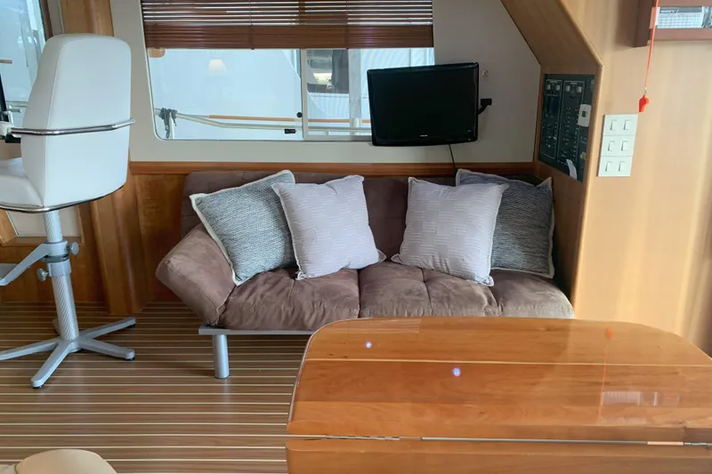 Slide: The Image of Interior of 2007 Mainship 34 Trawler with sofa, cushions, and mounted TV. - 20