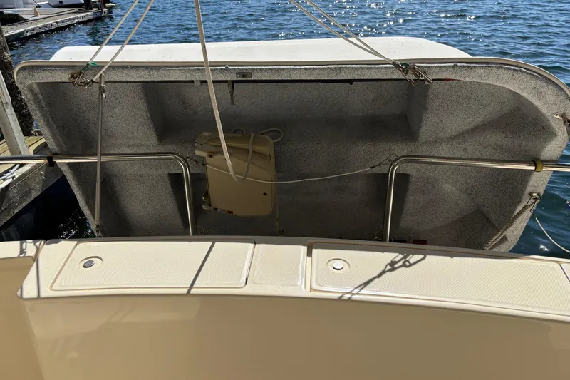 Slide: The Image of 2007 Mainship 34 Trawler boat deck with open hatch, docked by the water. - 5
