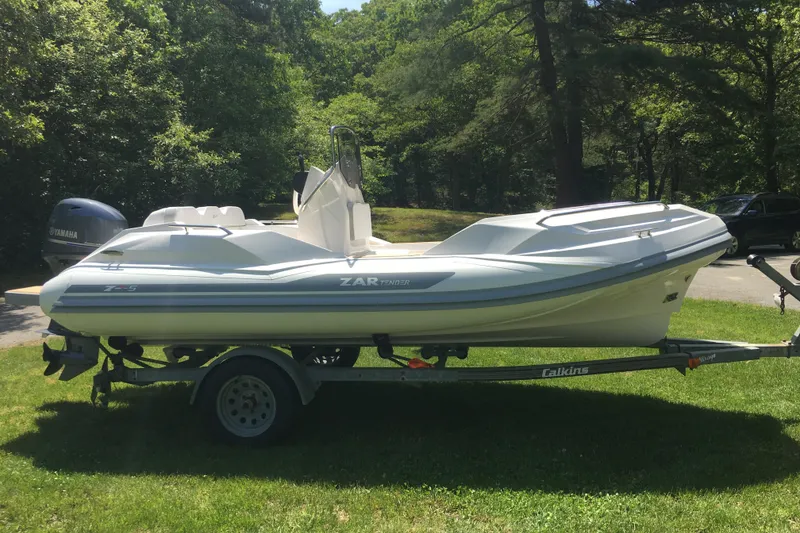 Slide: The Image of 2018 Zar Formenti 49 SL boat on trailer, parked on grass with trees in background. - 13