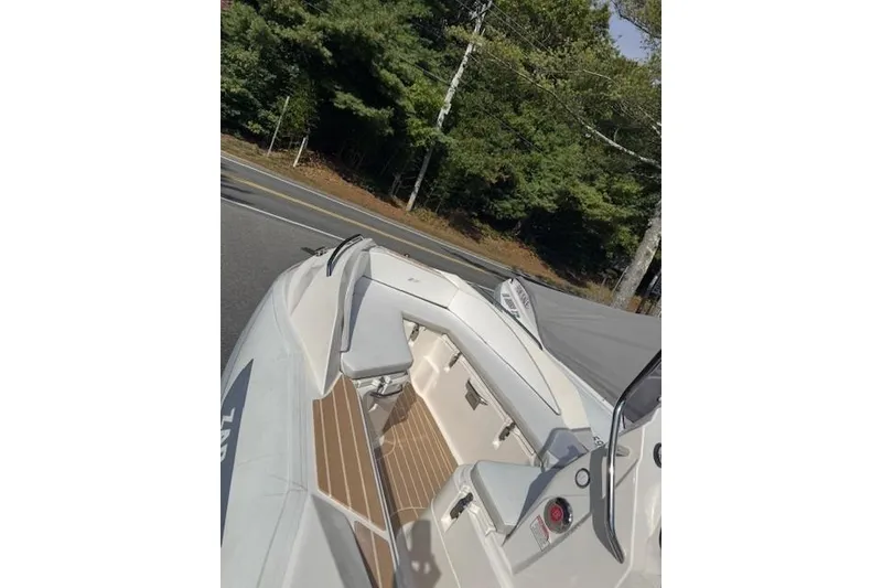 Slide: The Image of 2018 Zar Formenti 49 SL boat with wooden deck, parked near a forested road. - 2