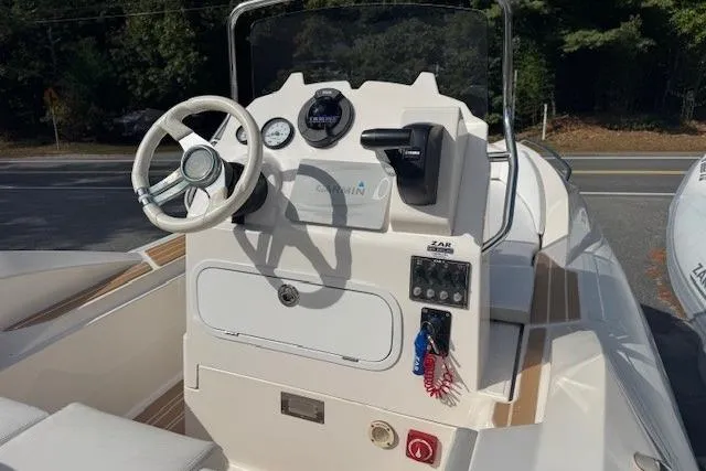 Slide: The Image of 2018 Zar Formenti 49 SL boat dashboard with steering wheel and controls. - 5