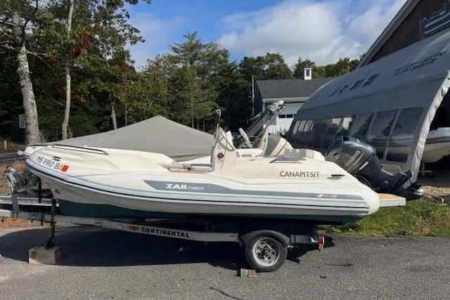 Slide: The Image of 2018 Zar Formenti 49 SL boat on trailer, parked outdoors near trees and a building. - 9