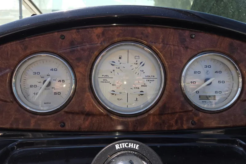 Slide: The Image of Dashboard of 2014 Rinker 290 Express Cruiser with speedometer and gauges. - 13