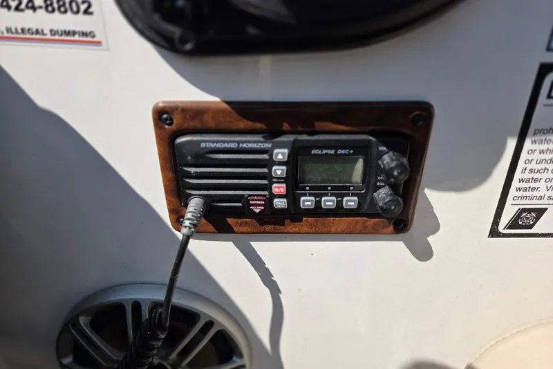 Slide: The Image of VHF radio on 2014 Rinker 290 Express Cruiser dashboard, featuring Standard Horizon Eclipse DSC+. - 14