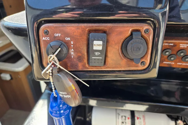 Slide: The Image of Control panel of a 2014 Rinker 290 Express Cruiser with ignition and blower switch. - 15