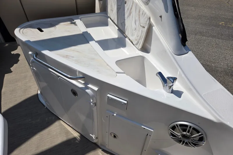 Slide: The Image of 2014 Rinker 290 Express Cruiser cockpit sink and storage area. - 25