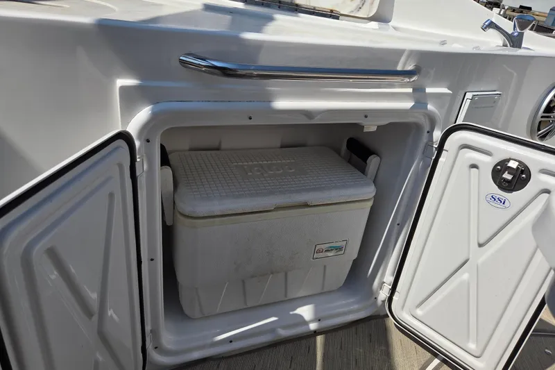 Slide: The Image of 2014 Rinker 290 Express Cruiser with built-in cooler storage compartment. - 26