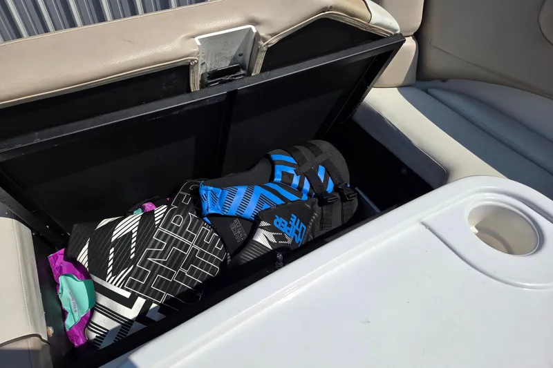 Slide: The Image of Storage compartment on 2014 Rinker 290 Express Cruiser with life jackets inside. - 28