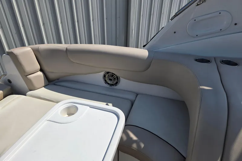 Slide: The Image of 2014 Rinker 290 Express Cruiser interior seating with table and cup holders. - 29