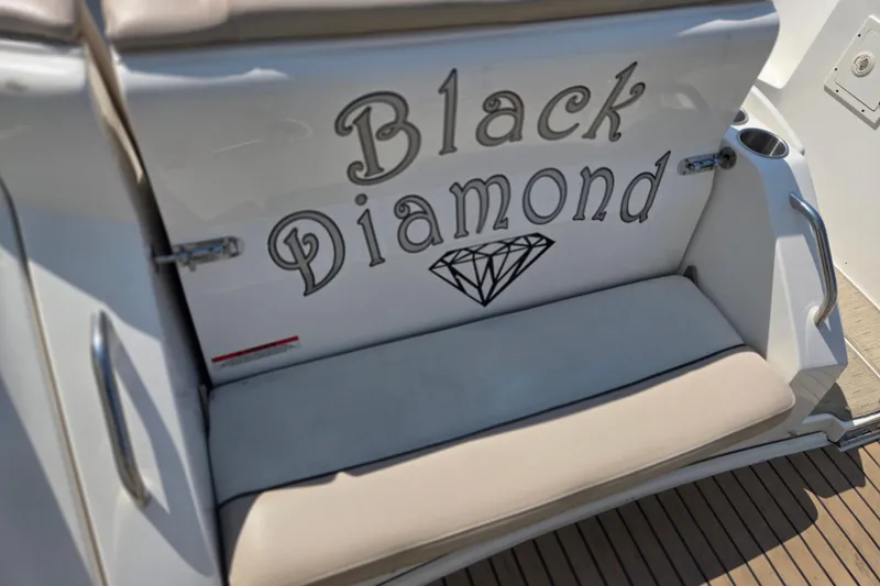 Slide: The Image of 2014 Rinker 290 Express Cruiser with "Black Diamond" name and diamond graphic on the seat. - 33