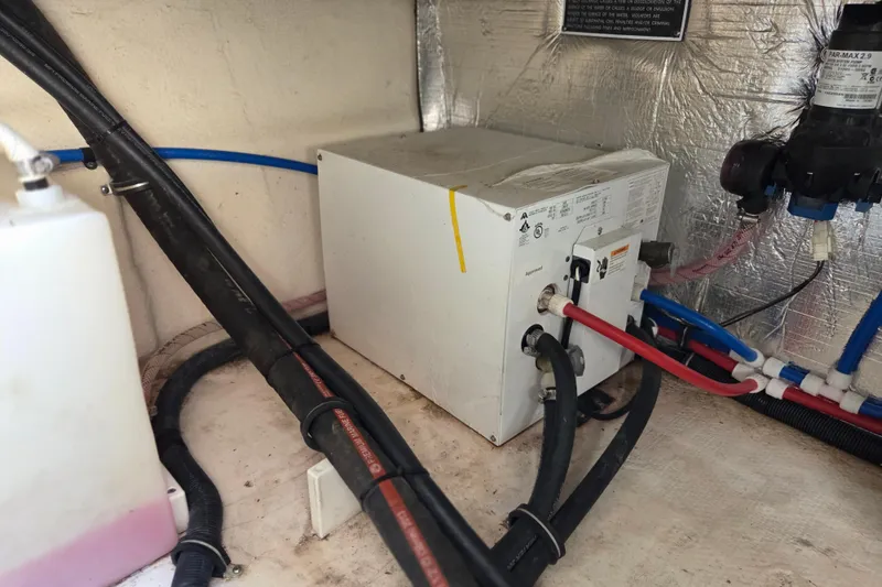 Slide: The Image of 2014 Rinker 290 Express Cruiser engine compartment with wiring and components. - 6