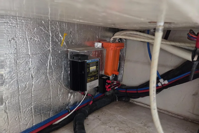 Slide: The Image of 2014 Rinker 290 Express Cruiser engine compartment with wiring and components. - 7