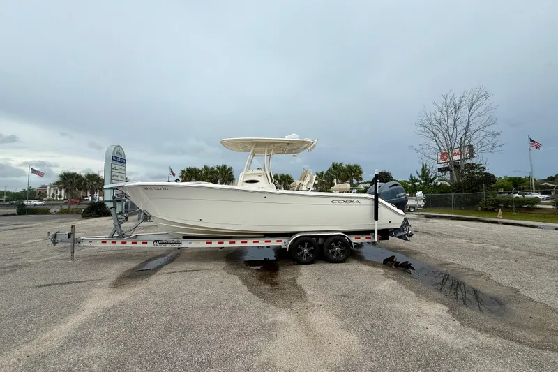 The Image of 2018 Cobia 261 Center Console boat on trailer in parking lot. - 0