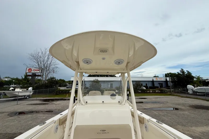 Slide: The Image of 2018 Cobia 261 Center Console boat with T-top, parked outdoors. - 13