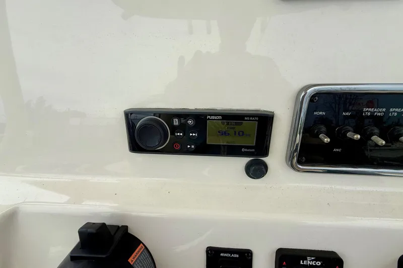 Slide: The Image of 2018 Cobia 261 Center Console dashboard with Fusion MS-RA70 stereo and control switches. - 15