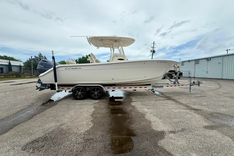 Slide: The Image of 2018 Cobia 261 Center Console boat on trailer in parking lot. - 4