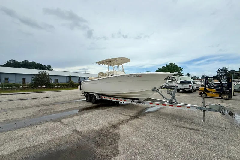 Slide: The Image of 2018 Cobia 261 Center Console boat on trailer in parking lot. - 5