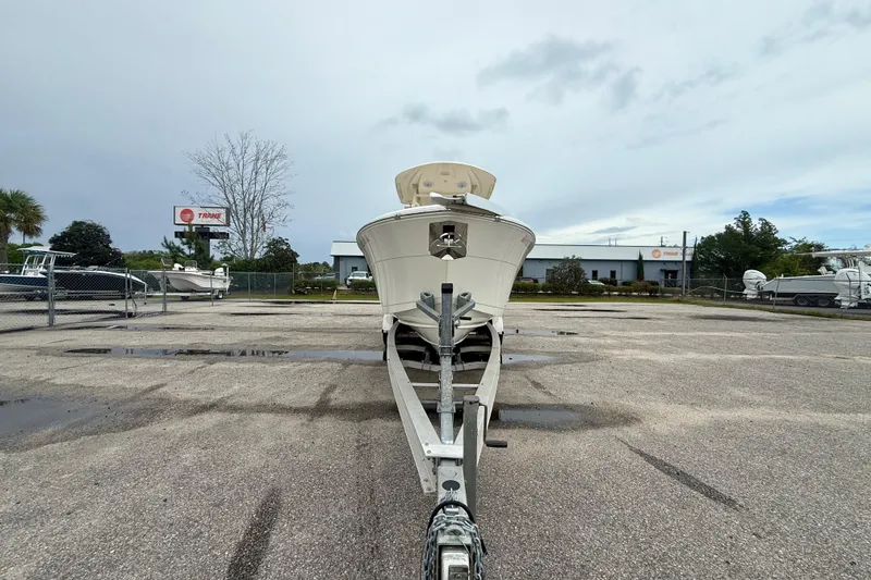 Slide: The Image of 2018 Cobia 261 Center Console boat on trailer in parking lot. - 6