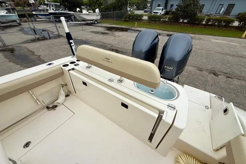 Slide: The Image of 2018 Cobia 261 Center Console boat with dual engines and spacious deck layout. - 8