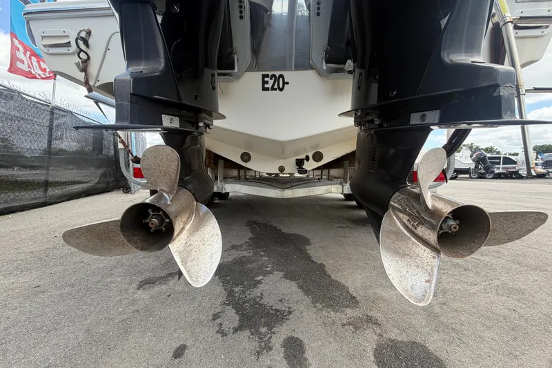 Slide: The Image of 2006 Ocean Runner 2900 C/C Open Fisherman boat propellers on display at a marina. - 13