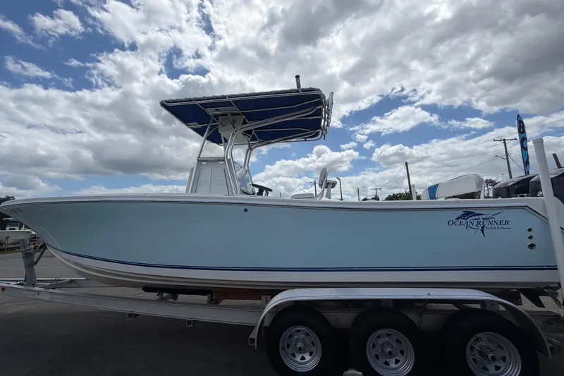Slide: The Image of 2006 Ocean Runner 2900 C/C Open Fisherman boat on trailer under cloudy sky. - 17
