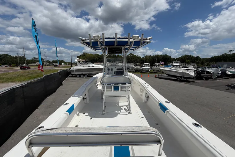 Slide: The Image of 2006 Ocean Runner 2900 C/C Open Fisherman boat at a marina under a cloudy sky. - 26