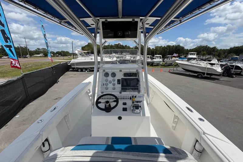 Slide: The Image of 2006 Ocean Runner 2900 C/C Open Fisherman boat interior with steering console and blue canopy. - 29