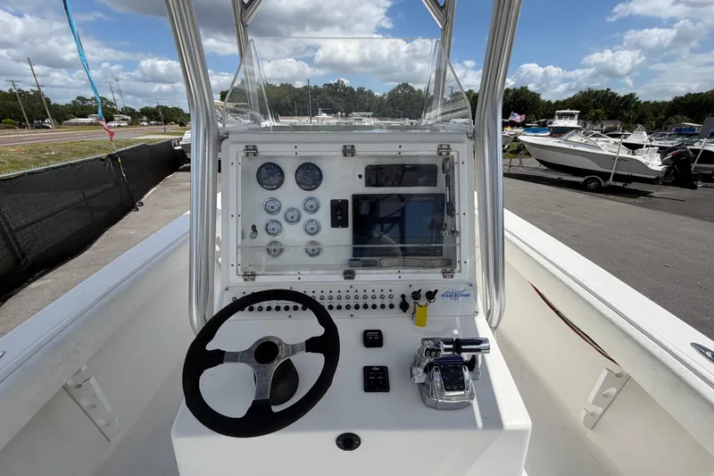 Slide: The Image of Center console of a 2006 Ocean Runner 2900 C/C Open Fisherman boat, featuring steering and controls. - 30
