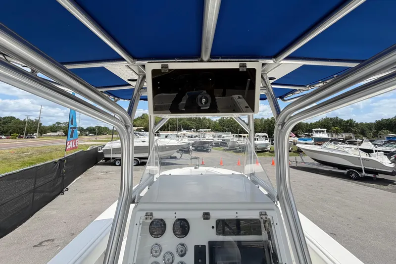 Slide: The Image of 2006 Ocean Runner 2900 C/C Open Fisherman boat dashboard with blue canopy at marina. - 35
