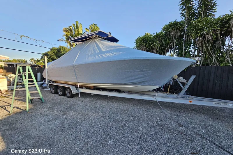 Slide: The Image of Covered 2006 Ocean Runner 2900 C/C Open Fisherman boat on trailer, parked outdoors. - 4