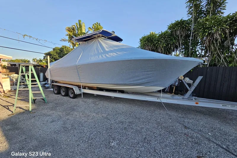 Slide: The Image of Covered 2006 Ocean Runner 2900 C/C Open Fisherman boat on trailer, parked outdoors. - 5