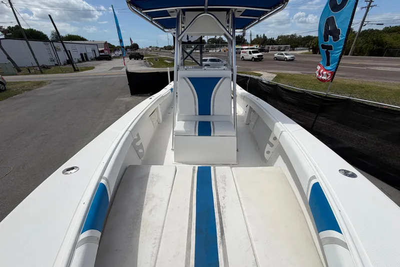 Slide: The Image of 2006 Ocean Runner 2900 C/C Open Fisherman boat with blue and white interior, docked outdoors. - 50