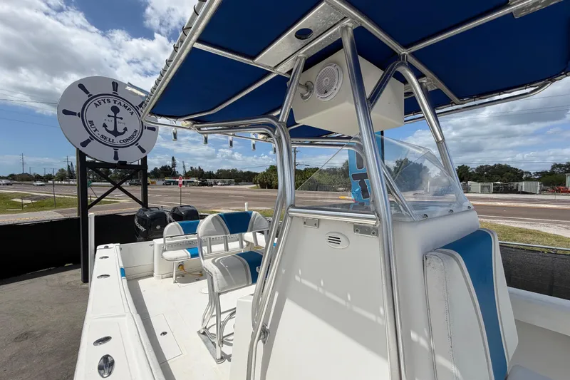 Slide: The Image of 2006 Ocean Runner 2900 C/C Open Fisherman boat with blue canopy and seating. - 55