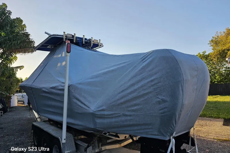 Slide: The Image of Covered 2006 Ocean Runner 2900 C/C Open Fisherman boat on trailer, parked outdoors. - 9