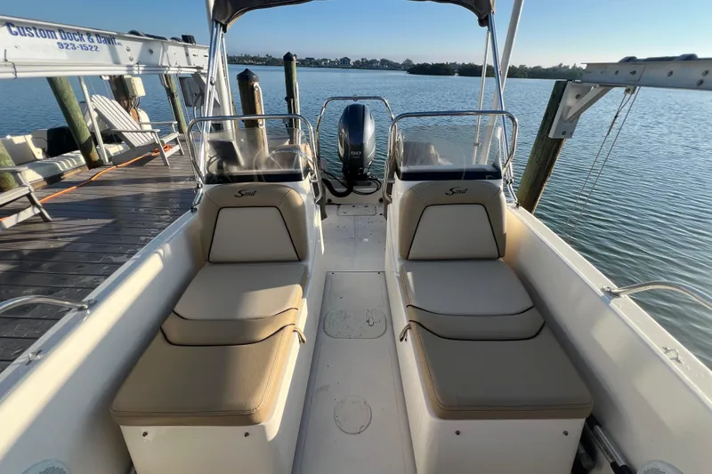 Slide: The Image of 2018 Scout 175 Sport Dorado boat docked by serene waterfront. - 7