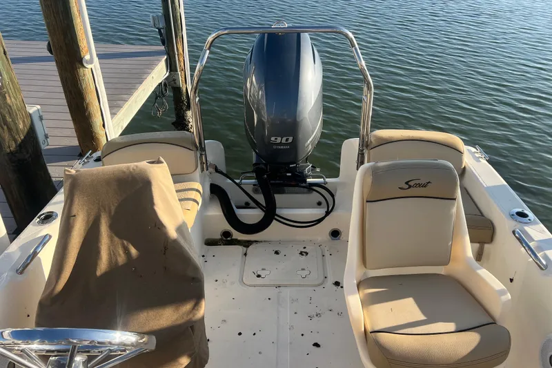 Slide: The Image of 2018 Scout 175 Sport Dorado boat interior with Yamaha 90 engine, docked by the water. - 8