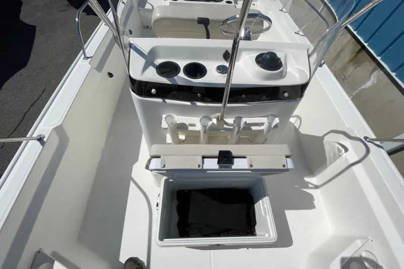 Slide: The Image of 2019 Boston Whaler 190 Montauk boat interior with console and storage compartment. - 3