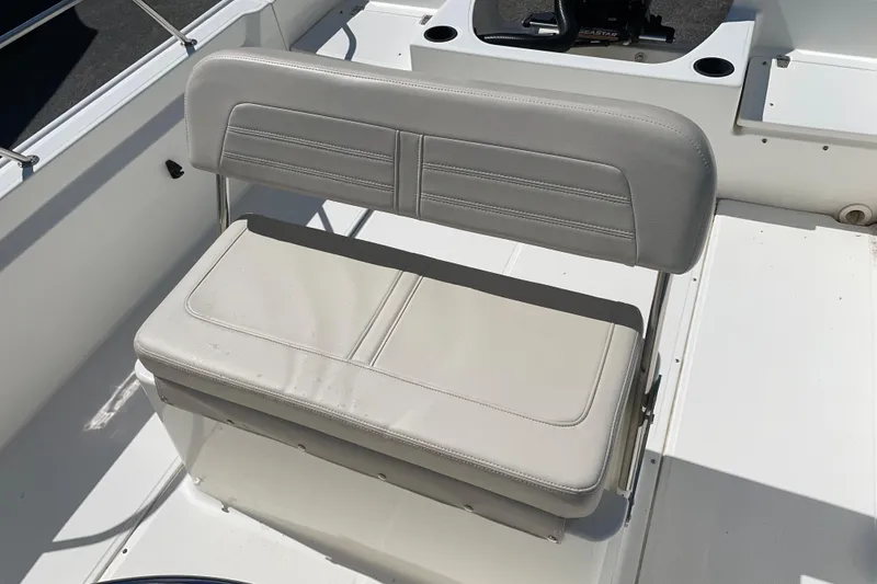 Slide: The Image of 2019 Boston Whaler 190 Montauk boat seat, featuring light gray upholstery and sturdy design. - 4