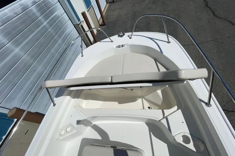 Slide: The Image of 2019 Boston Whaler 190 Montauk boat interior with cushioned seating and stainless steel railings. - 8