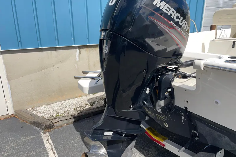 Slide: The Image of 2019 Boston Whaler 190 Montauk with Mercury FourStroke outboard engine, parked outdoors. - 9