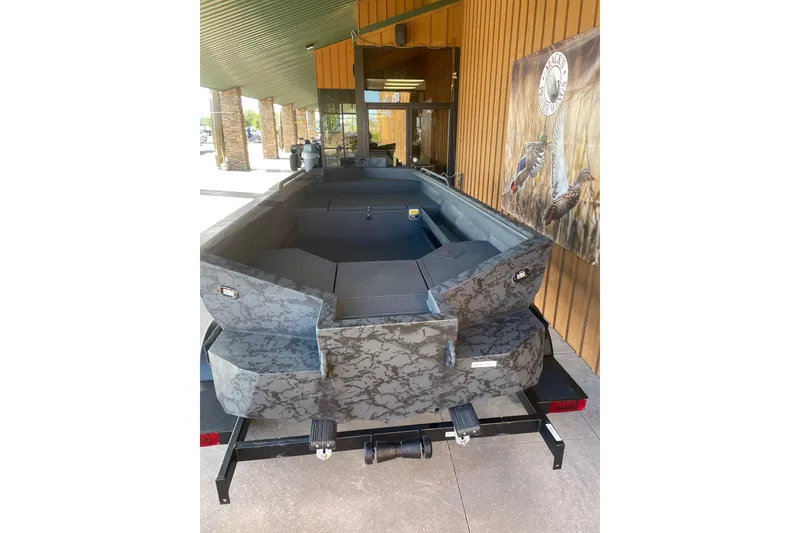 Slide: The Image of 2026 Reaper Boats 553 Timber Reaper with camouflage design, displayed outdoors. - 10